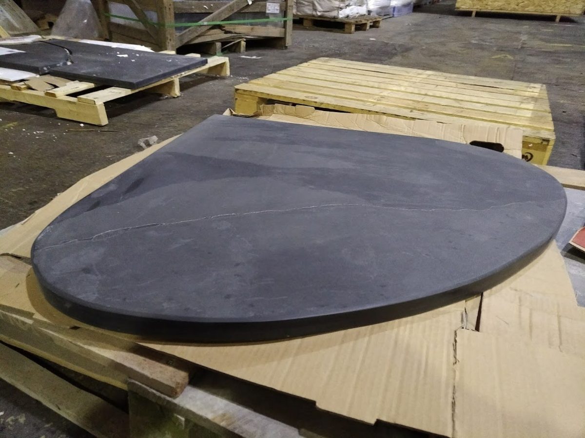 Wide teardrop shaped bespoke slate hearth for a corner