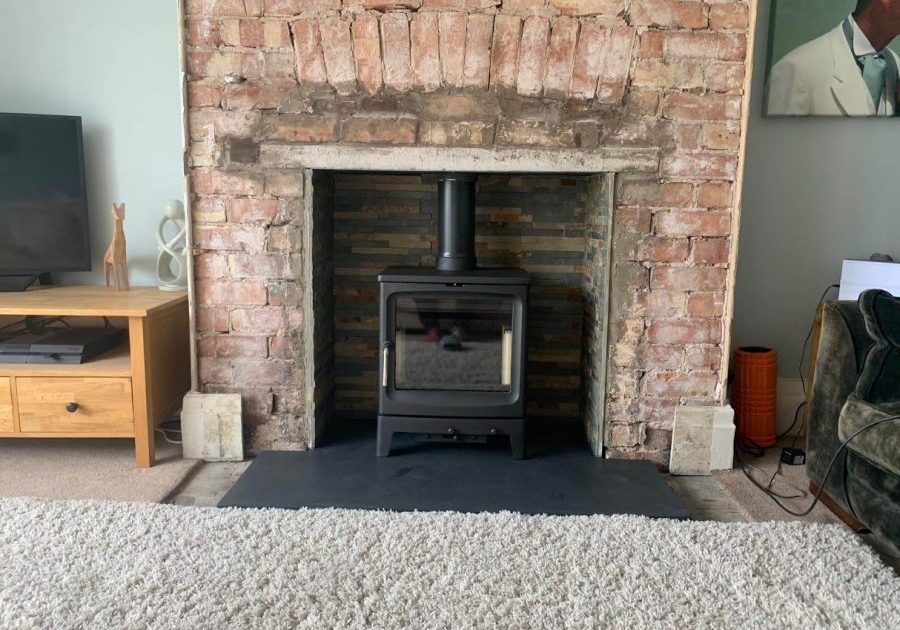 Brick living room fireplace with a T-shaped made-to-measure slate hearth