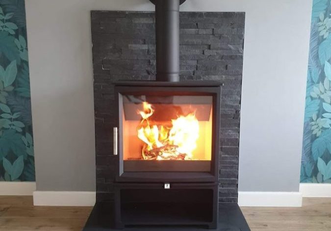 Contemporary square slate hearth now in use with its stove