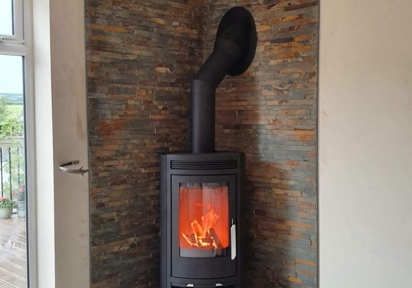 One of our bespoke five-sided pentagonal slate hearths with a corner stove